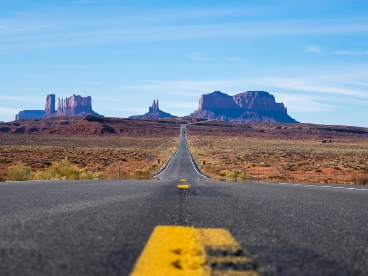 Highway built through open western landscape